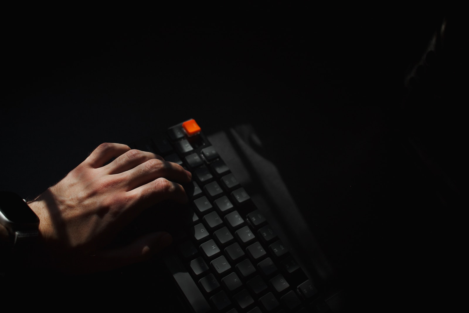 person holding black computer keyboard